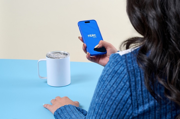 Two hands holding a green wallet symbolizing assistance